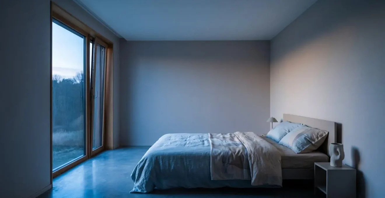 Minimalist wide-angle bedroom interior emphasizing cool ambient temperature and optimal sleep conditions