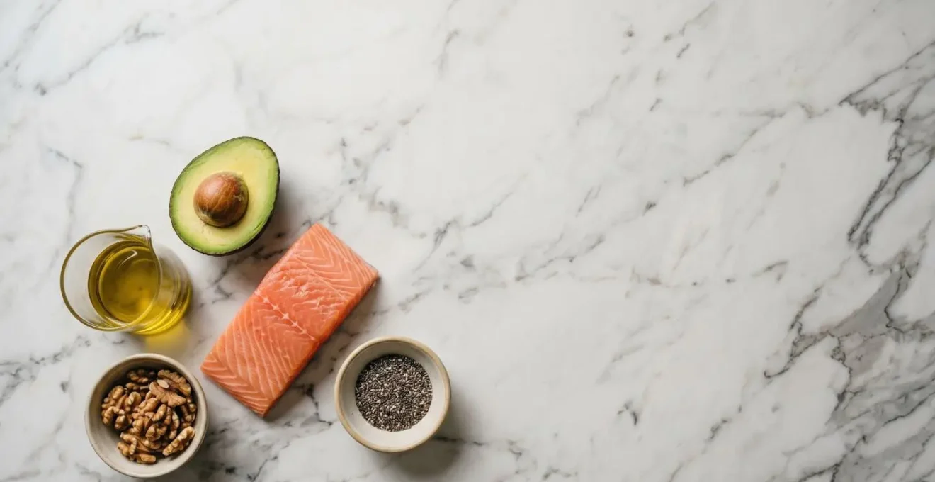 Wide environmental photograph showing natural whole food ingredients in minimalist kitchen setting emphasizing healthy fat sources